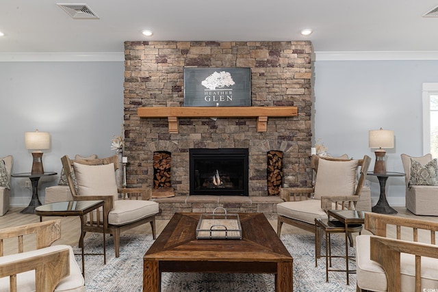 living room featuring hardwood / wood-style flooring, ornamental molding, and a fireplace