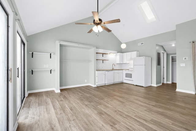 kitchen with white appliances, white cabinets, a skylight, light hardwood / wood-style flooring, and ceiling fan