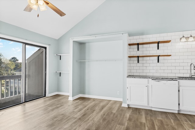 interior space featuring backsplash, white dishwasher, sink, white cabinets, and light hardwood / wood-style floors