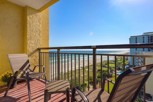 balcony with a water view and a beach view