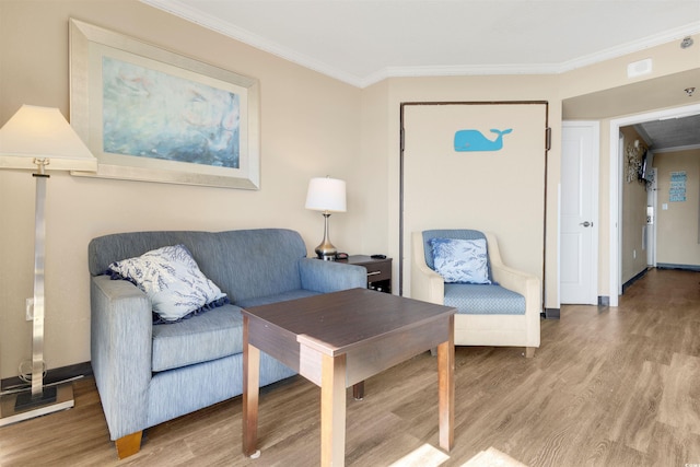 living room with hardwood / wood-style flooring and crown molding