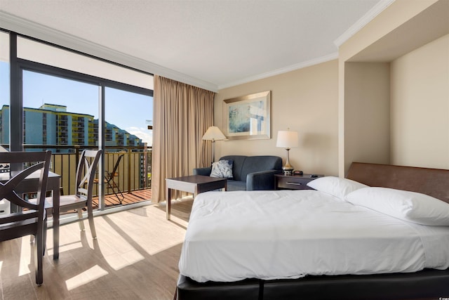 bedroom featuring floor to ceiling windows, light hardwood / wood-style flooring, and ornamental molding