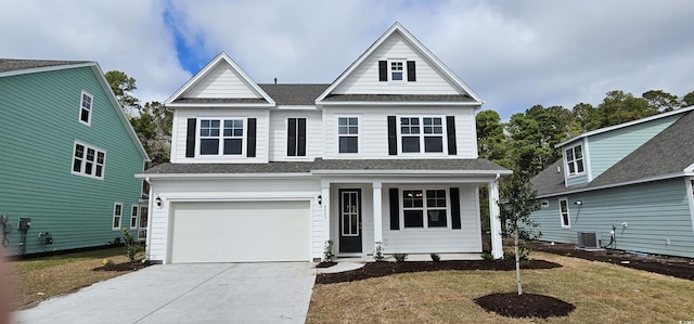 view of front of home with cooling unit, a garage, and a front lawn