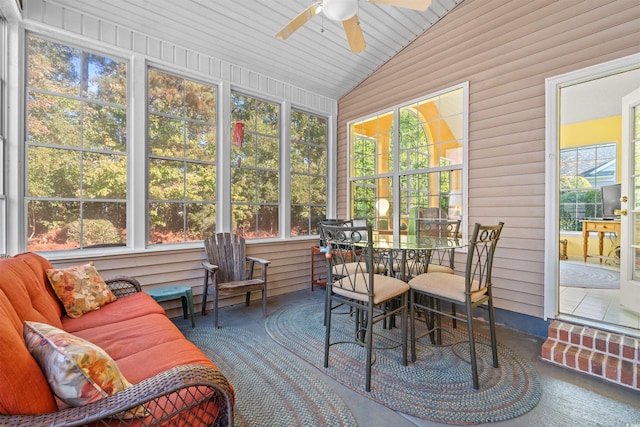 sunroom / solarium with wood ceiling, ceiling fan, a healthy amount of sunlight, and lofted ceiling