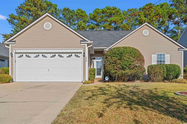 view of front of property featuring a front yard and a garage