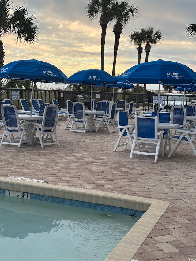 view of pool at dusk