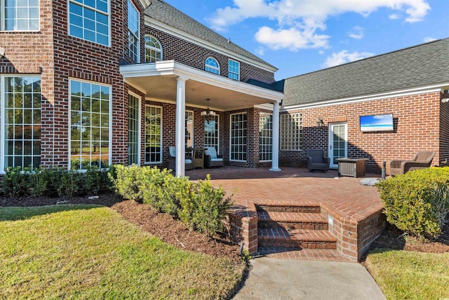 3754 Annandale Dr, Myrtle Beach, SC 29577 - rear view of property with brick siding, a patio area, roof with shingles, and a yard