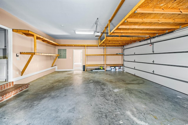 garage featuring electric panel and a garage door opener