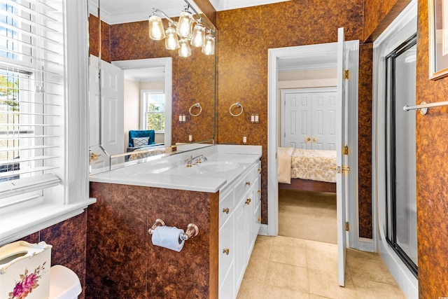 bathroom featuring tile patterned flooring, toilet, vanity, a shower with shower door, and ornamental molding