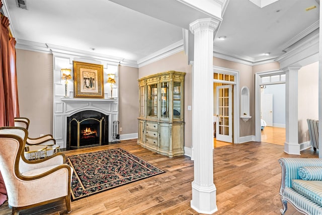 3754 Annandale Dr, Myrtle Beach, SC 29577 - living area with decorative columns, a large fireplace, crown molding, wood finished floors, and recessed lighting