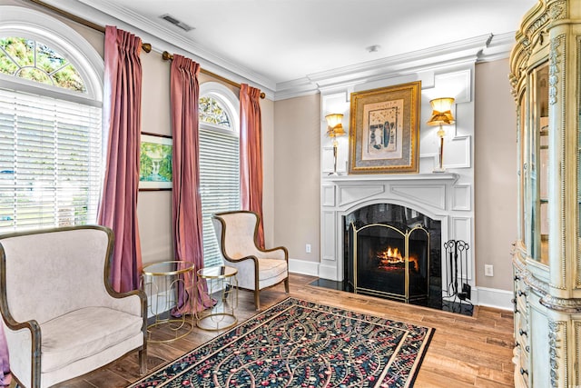 3754 Annandale Dr, Myrtle Beach, SC 29577 - sitting room featuring a fireplace, crown molding, and wood finished floors
