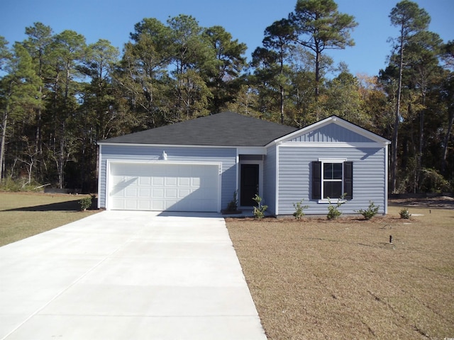 view of front of property with a garage and a front lawn