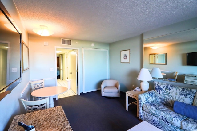 carpeted living room with a textured ceiling