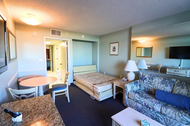 bedroom with carpet flooring and a textured ceiling