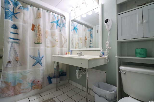 bathroom with tile patterned flooring, curtained shower, and toilet