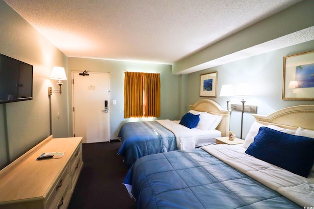 carpeted bedroom with a textured ceiling