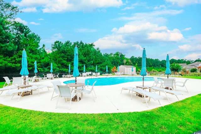 view of swimming pool with a storage unit