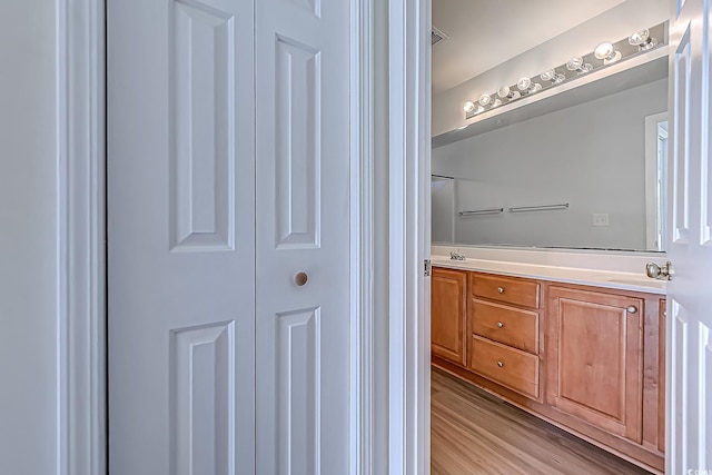 bathroom featuring vanity and hardwood / wood-style flooring