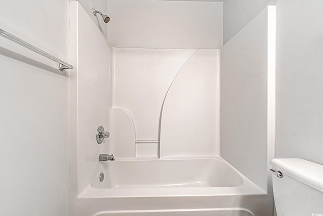 bathroom featuring shower / bathing tub combination and toilet