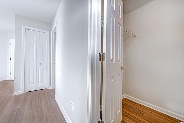 corridor with light wood-type flooring