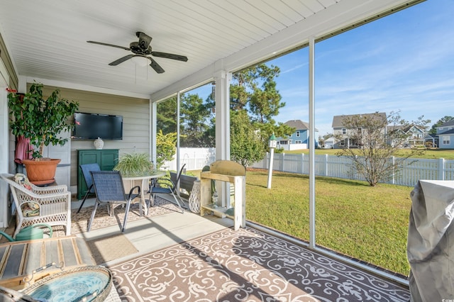 sunroom featuring ceiling fan