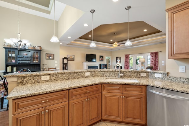 living room featuring ceiling fan with notable chandelier, light hardwood / wood-style floors, and a raised ceiling