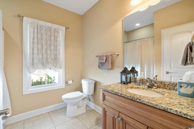 bathroom featuring toilet, vanity, and tile patterned floors