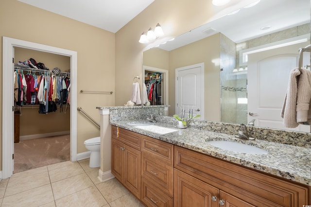 bathroom featuring toilet, vanity, and tile patterned floors