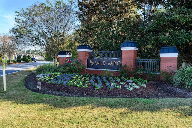 community / neighborhood sign featuring a lawn