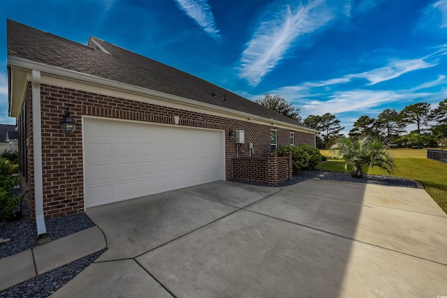 view of property exterior featuring a yard and a garage