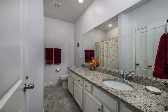 bathroom with vanity and toilet