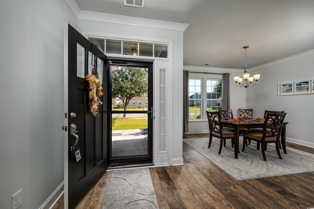 entrance foyer with a chandelier, dark hardwood / wood-style flooring, and crown molding