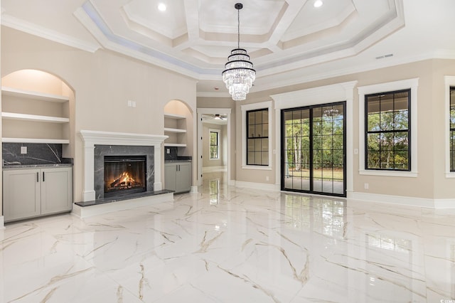 unfurnished living room featuring crown molding, built in features, and a high end fireplace