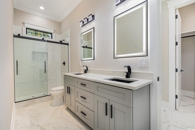 bathroom featuring vanity, toilet, a shower with shower door, and crown molding