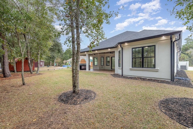 view of yard featuring a storage unit and ceiling fan