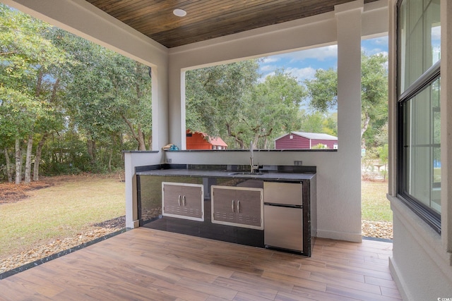 view of patio / terrace featuring an outdoor kitchen and sink