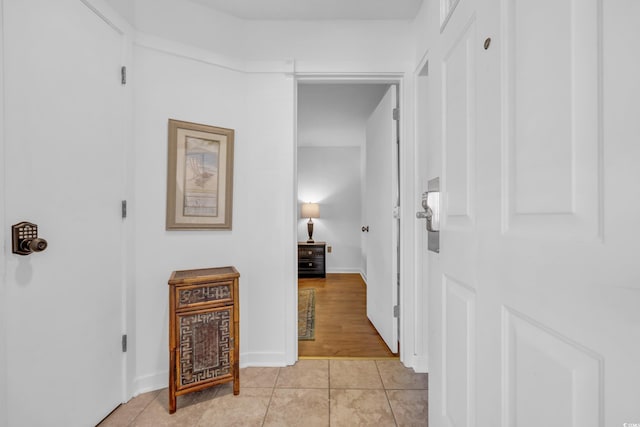 corridor with light tile patterned floors