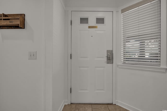 doorway to outside featuring light tile patterned floors