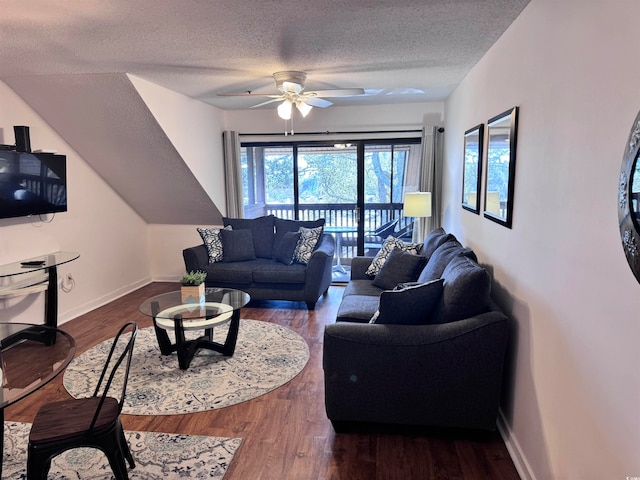 living room with ceiling fan, dark hardwood / wood-style flooring, and a textured ceiling