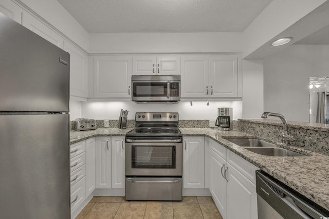 kitchen featuring sink, white cabinets, and stainless steel appliances