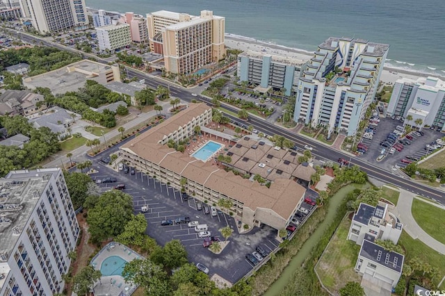 birds eye view of property with a city view and a water view