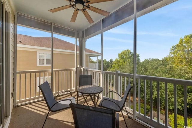 sunroom / solarium featuring ceiling fan