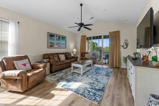 living room featuring light hardwood / wood-style flooring, vaulted ceiling, and ceiling fan