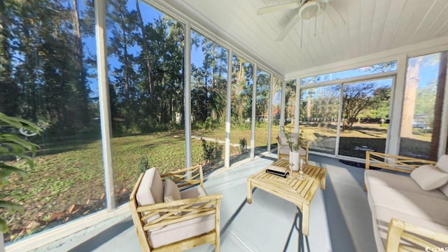 sunroom / solarium featuring ceiling fan