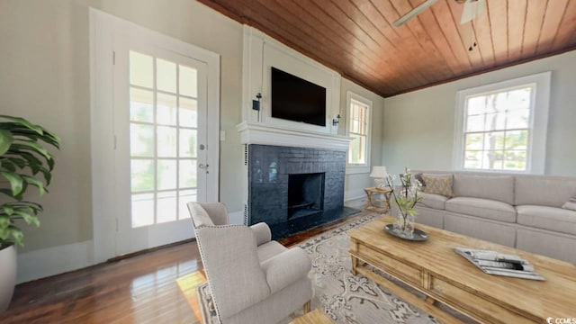 living room featuring hardwood / wood-style flooring, ceiling fan, ornamental molding, and wood ceiling