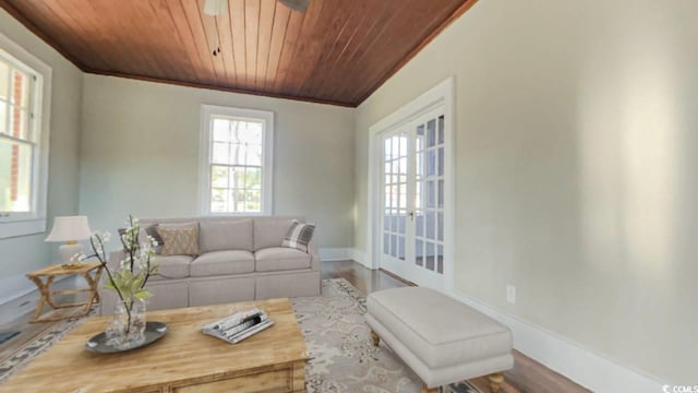 living room featuring wood-type flooring, wooden ceiling, ornamental molding, and french doors