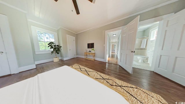 bedroom featuring dark hardwood / wood-style flooring, ensuite bath, ceiling fan, and ornamental molding