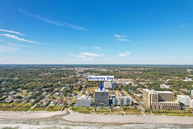 birds eye view of property featuring a water view and a beach view