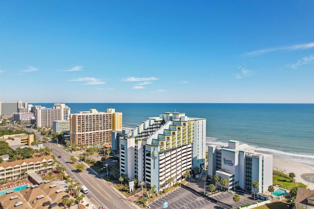 birds eye view of property with a beach view and a water view