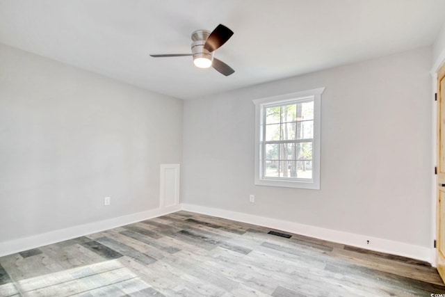 empty room with light hardwood / wood-style flooring and ceiling fan